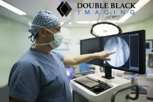 Surgeon with Double Black Imaging Monitor